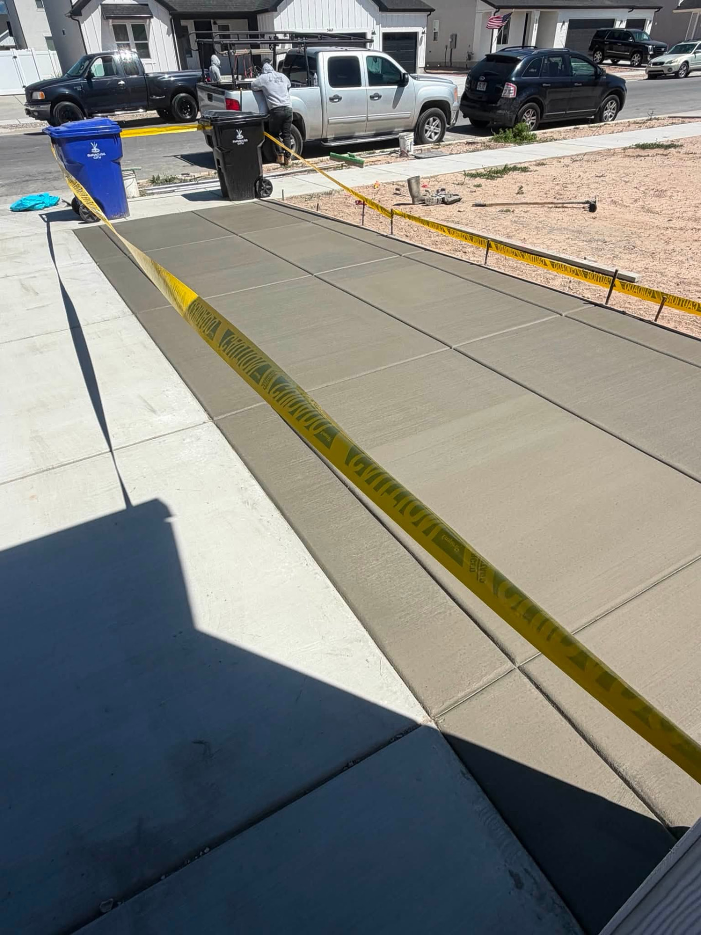 Freshly finished residential concrete driveway with clean control joints