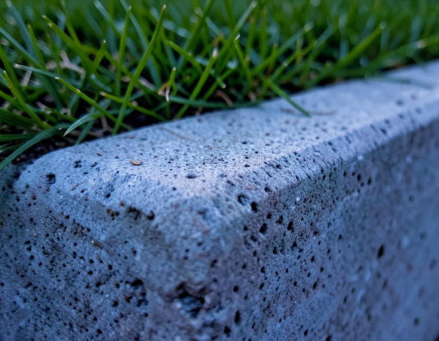 Tooled concrete edge meeting grass