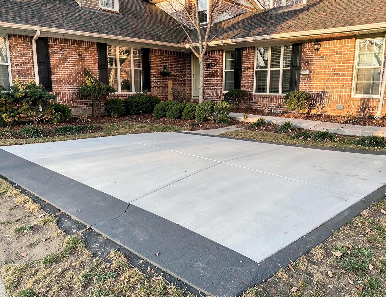 Finished concrete driveway with a contrasting charcoal border